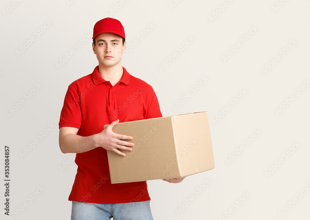 Work at post office. Courier holding big parcel Work at post office. Courier holding big parcel