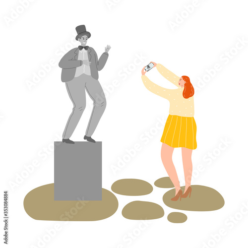 Girl making photo of man mime street atrist showing statue
