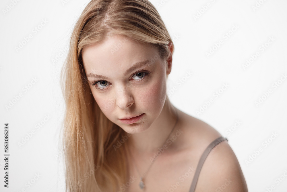 pretty caucasian girl with naked shoulders looking at camera. beauty portrait, close up. beautiful woman with perfect clean skin on white studio background. soft focus on her face pretty caucasian girl with naked shoulders looking at camera. beauty portrait, close up. beautiful woman with perfect clean skin on white studio background. soft focus on her face
