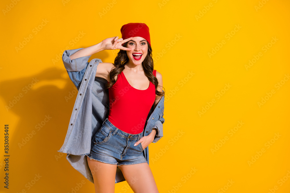 Portrait of funny crazy youngster teen girl enjoy weekend free time holiday make v-sign wear red denim tank-top isolated over bright color background Portrait of funny crazy youngster teen girl enjoy weekend free time holiday make v-sign wear red denim tank-top isolated over bright color background