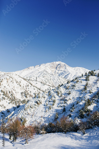 Snowy mountain peaks covered with snow on a frosty winter day