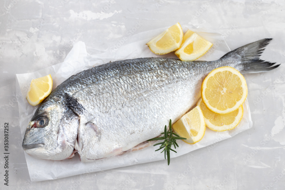 raw fish on white paper on ceramic background raw fish on white paper on ceramic background