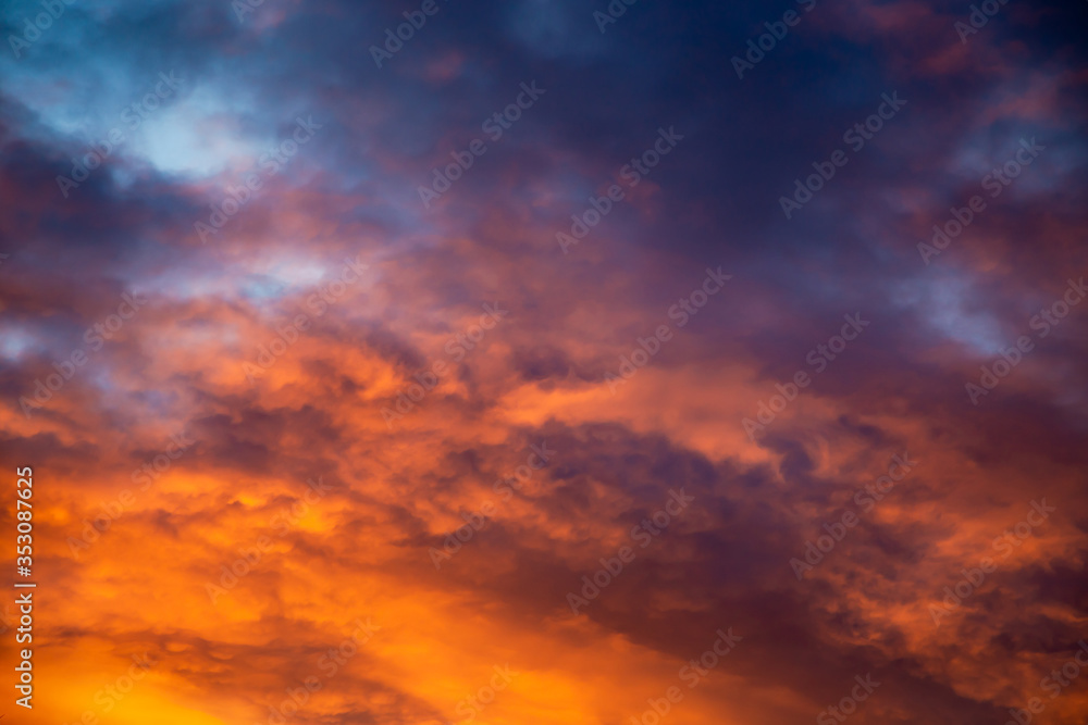 Colorful image of dramatic cloudscape. Amazing clouds of pink, red, violet,  gray color on the background of the evening dark sky after sunset.