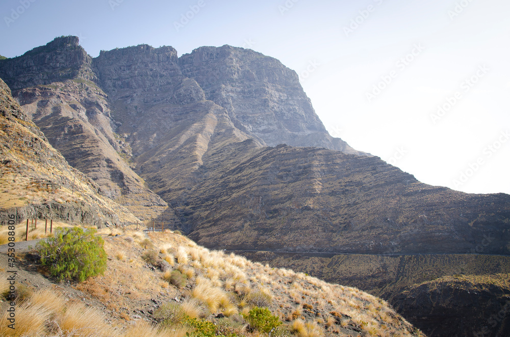 Volcanic edge cliff. Blue sky at the sunset. Canary Islands, Spain. Volcanic edge cliff. Blue sky at the sunset. Canary Islands, Spain.