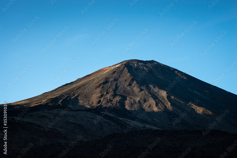 Mount Ngauruhoe at sunrise, viewed from the track of Tongariro Alpine Crossing Mount Ngauruhoe at sunrise, viewed from the track of Tongariro Alpine Crossing