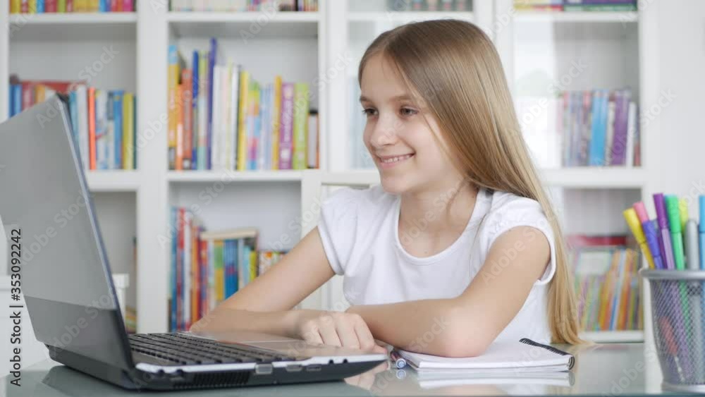 Kid Using Laptop Studying in Video Conferencing, Child Learning, Writing in Library, Schoolgirl Chatting with Teacher from Home, Children Homeschooling, Online Education Kid Using Laptop Studying in Video Conferencing, Child Learning, Writing in Library, Schoolgirl Chatting with Teacher from Home, Children Homeschooling, Online Education