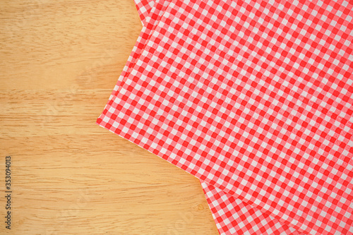 red and white classic tablecloth on wooden background 