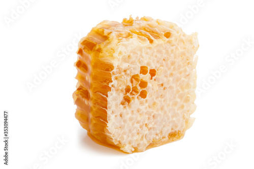 Close up honey slice isolated on white background. Natural beehive. Honeycomb piece with clipping path.