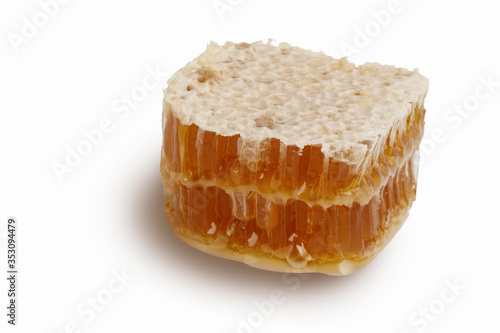 Honey slice isolated on white background. Natural beehive. Honeycomb piece with clipping path.