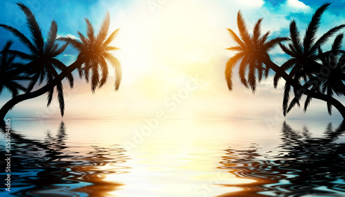 Tropical sunset with palm trees and sea. Silhouettes of palm trees on the beach against the sky with clouds. Reflection of palm trees on the water. © Laura Сrazy