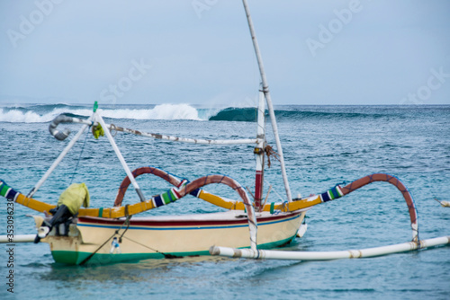 boat on the beach and a perfect wave braking photo