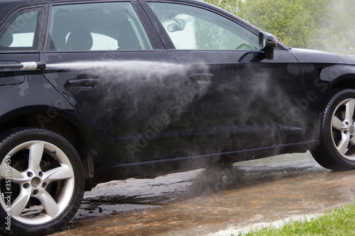 Cleaning car using high pressure water. outdoor. © Елена Таленец