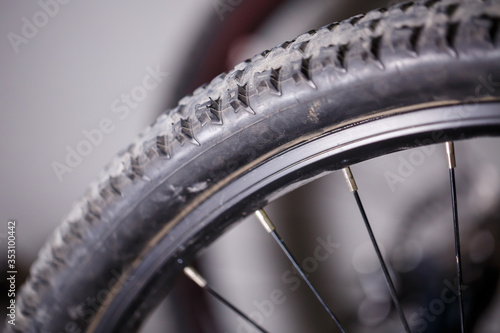 Black rubber tire with spikes for a bicycle wheel. Bike accessories