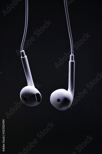 White earphone with black background. Earphone and audio jack with black background.