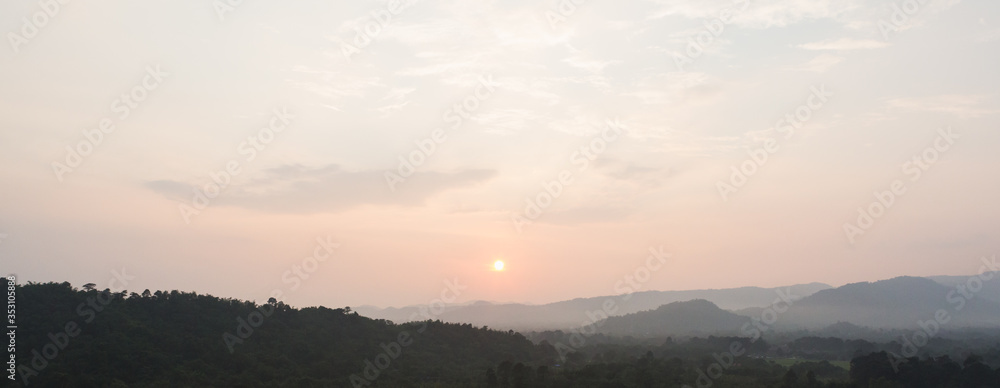 Sunset scene with silhouette mountain at Khun Dan Prakan Chon Dam	