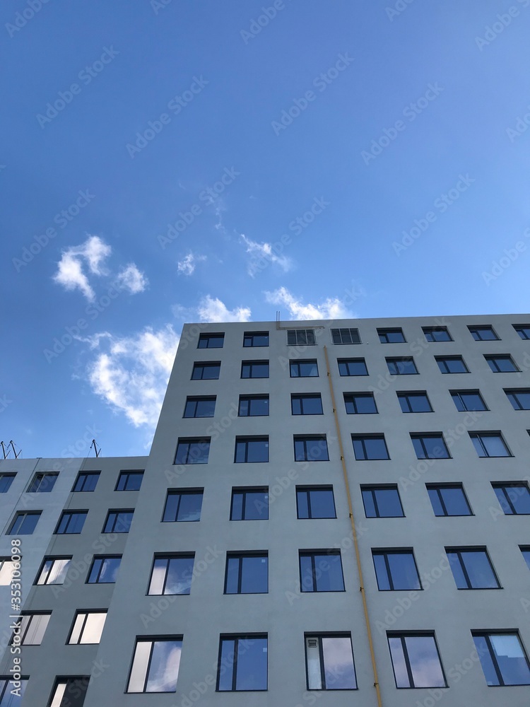 modern office building on a background of clouds modern office building on a background of clouds