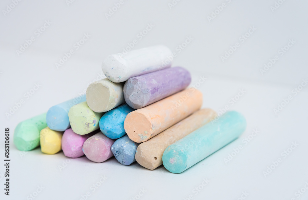 Colored crayons, stacked on top of each other, slide. Variety of color. Background, texture. Space for text