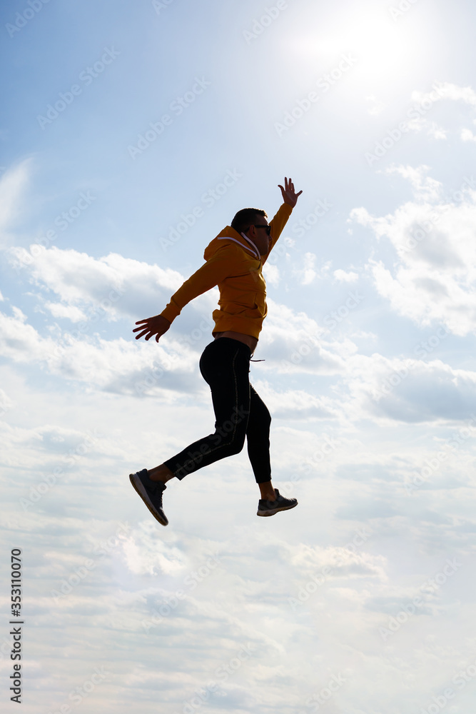 guy tourist freelancer on a background of blue sky with white clouds, bright sunny day, nature and human freedom