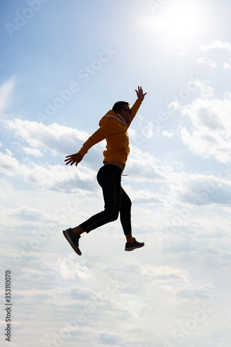 guy tourist freelancer on a background of blue sky with white clouds, bright sunny day, nature and human freedom
