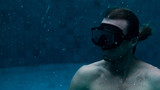 sporty man swimming in mask in pool