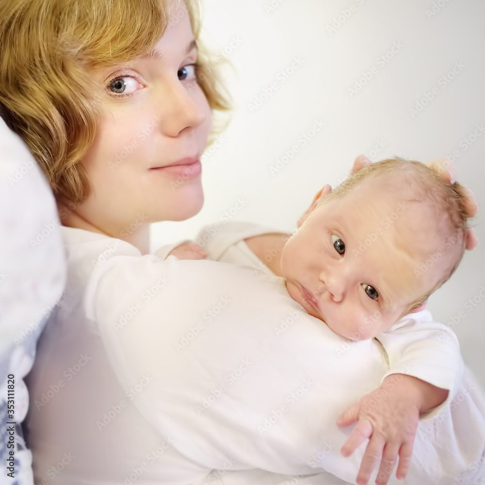 Mother holding her tiny newborn baby. Woman enjoy her first day's as a young mom with cute infant child. Mother day. Mother holding her tiny newborn baby. Woman enjoy her first day's as a young mom with cute infant child. Mother day.