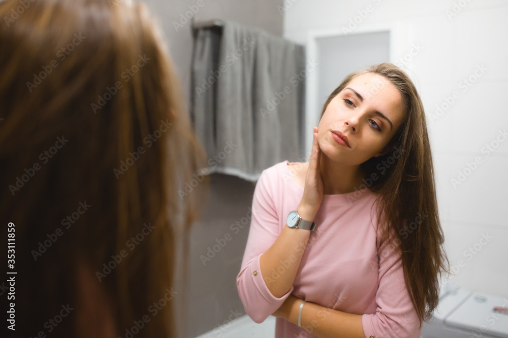 young woman in bathroom , face problems