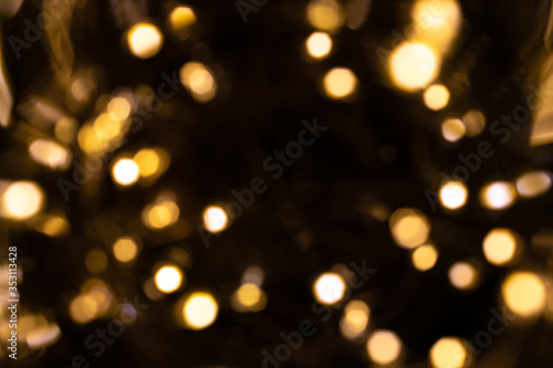Background texture glitter. Abstract gold Festive lights. Blur Bokeh glamor.