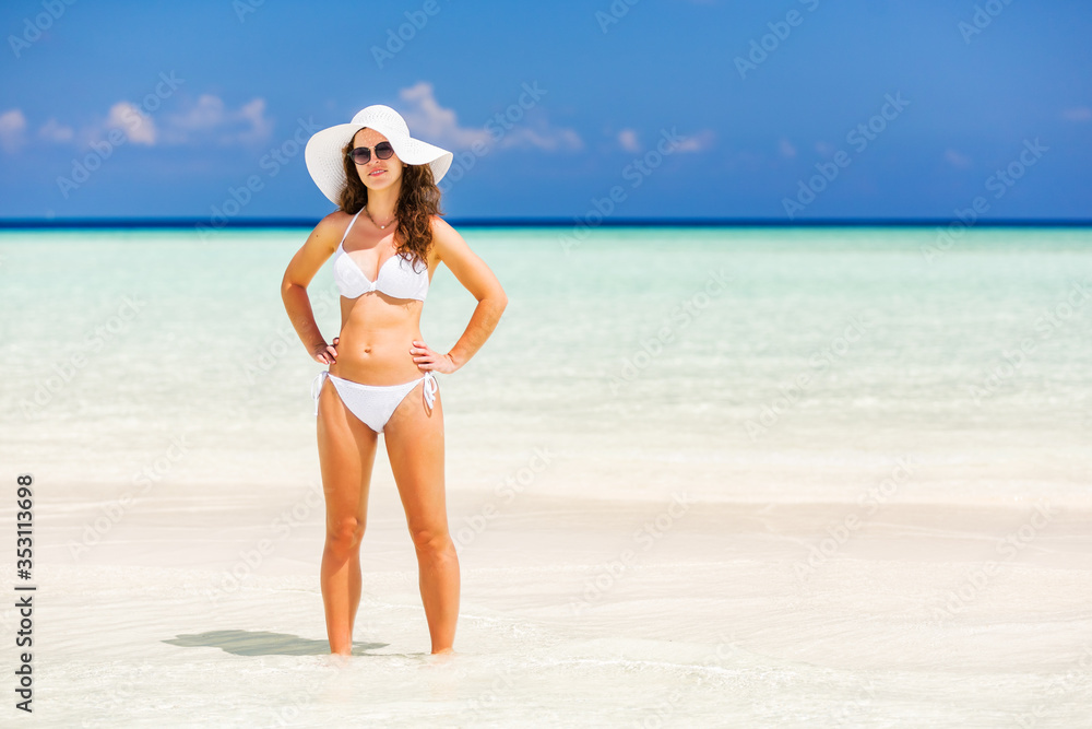 Happy young woman in bikini enjoing the beautiful ocean beach on Maldives Happy young woman in bikini enjoing the beautiful ocean beach on Maldives