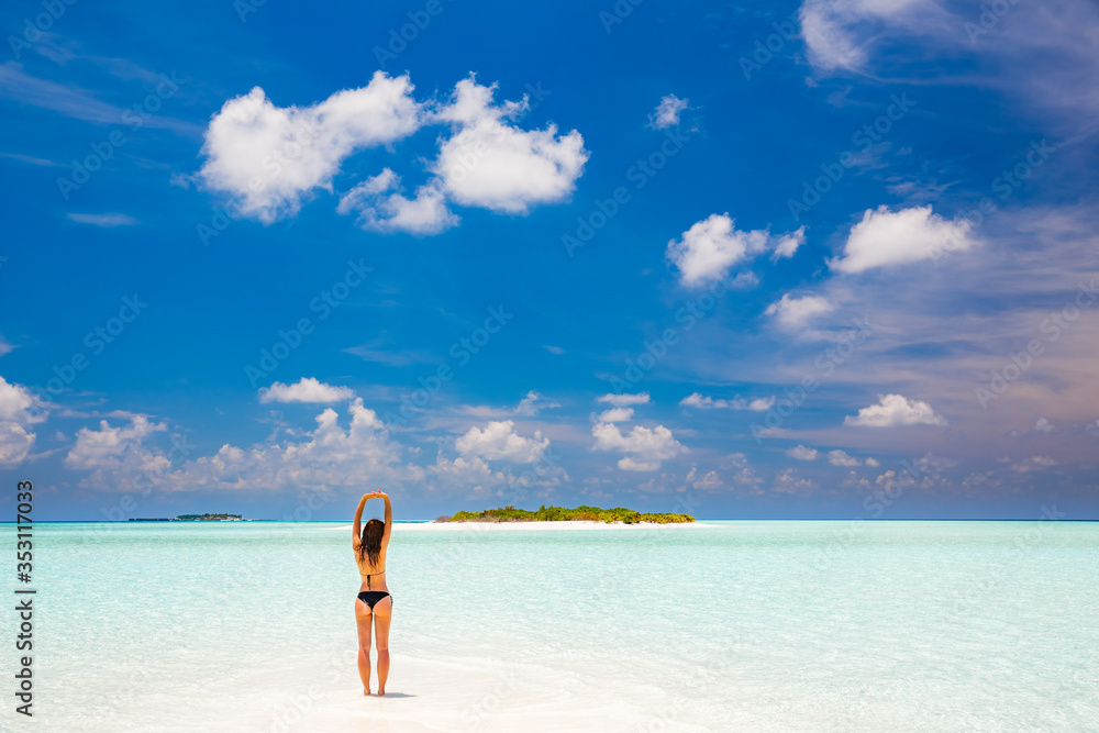 Young woman in bikini enjoing the beautiful ocean beach on Maldives Young woman in bikini enjoing the beautiful ocean beach on Maldives