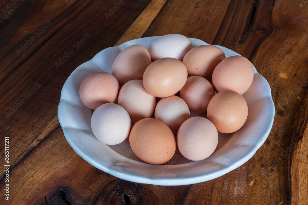 fresh brown and white chicken eggs on a plate on wooden background fresh brown and white chicken eggs on a plate on wooden background