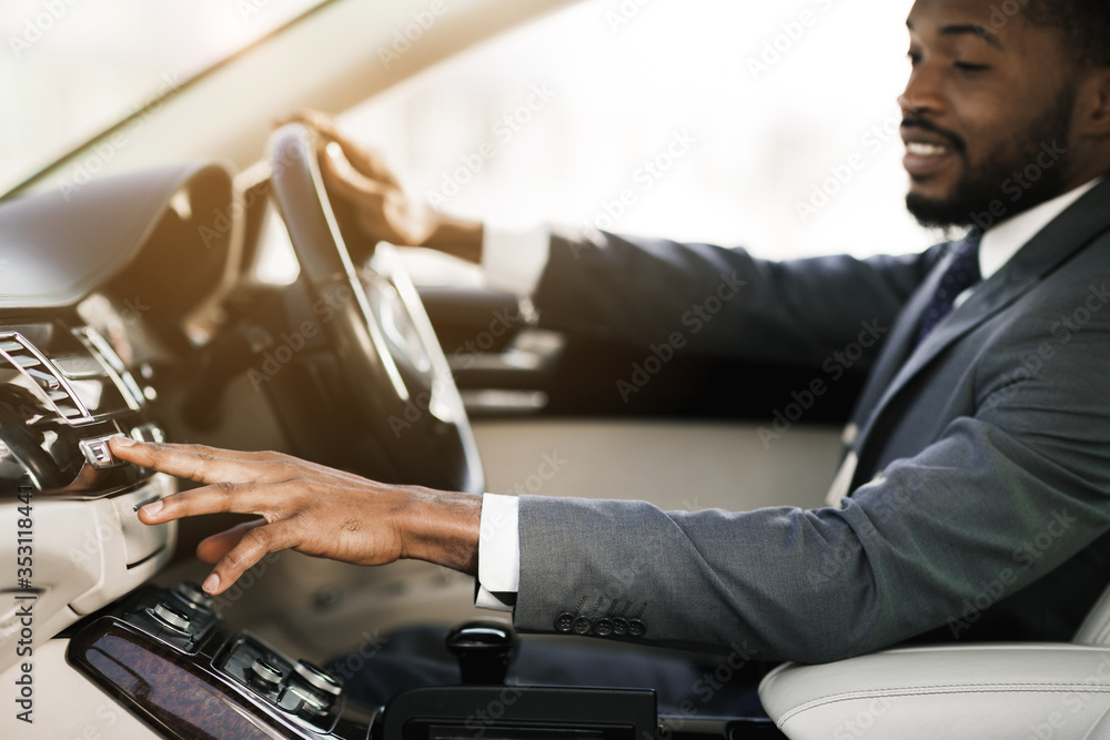 Unrecognizable African Driver Driving Car Pushing Button Sitting In Auto Unrecognizable African Driver Driving Car Pushing Button Sitting In Auto