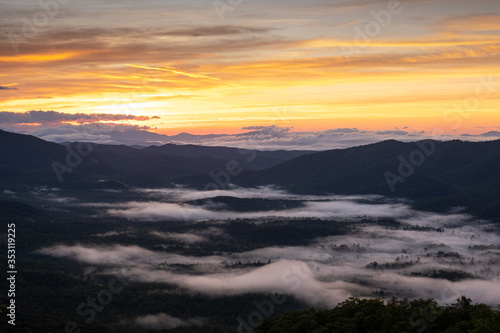 Scenic sunrise view of the Blue Ridge Mountains near Asheville, North Carolina from the Blue Ridge Parkway, a scenic byway stretching across the mountains of western NC.