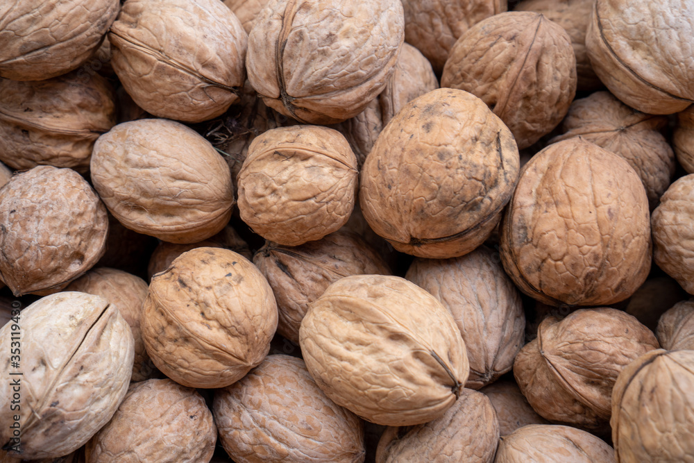 Natural walnut background pattern texture Abstract walnuts heap pattern background Blurred edges frame Natural food in-shell nuts walnuts pattern backdrop Walnuts in shell background dramatic contrast Natural walnut background pattern texture Abstract walnuts heap pattern background Blurred edges frame Natural food in-shell nuts walnuts pattern backdrop Walnuts in shell background dramatic contrast