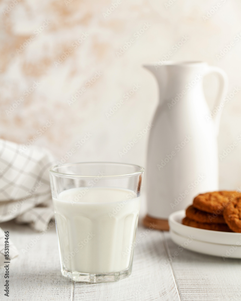 Glass of milk, jug, cookies. The concept of dairy products, the use of milk, farm products. Copy space. Vertical photo. Glass of milk, jug, cookies. The concept of dairy products, the use of milk, farm products. Copy space. Vertical photo.