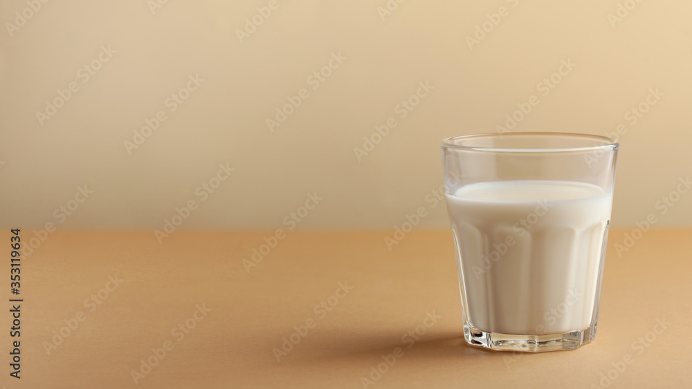 Banner of a glass of milk on a brown background. The concept of farm dairy products, the use of milk. Copy space. Banner of a glass of milk on a brown background. The concept of farm dairy products, the use of milk. Copy space.