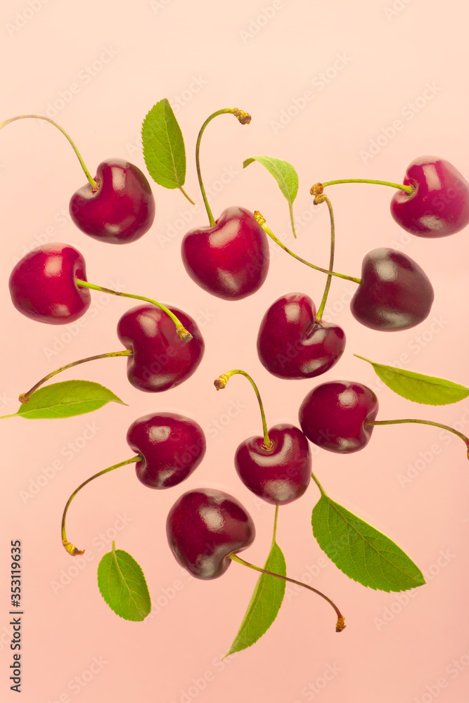 Cherry minimal background. Red summer cherry berries on a pink empty blue background. Summer fruits and food concept. Cherry minimal background. Red summer cherry berries on a pink empty blue background. Summer fruits and food concept.