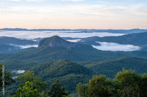 Scenic sunrise view from the Blue Ridge Parkway of Looking Glass Rock, a popular climbing and hiking destination attraction in Pisgah Forest of Brevard, near Asheville, North Carolina