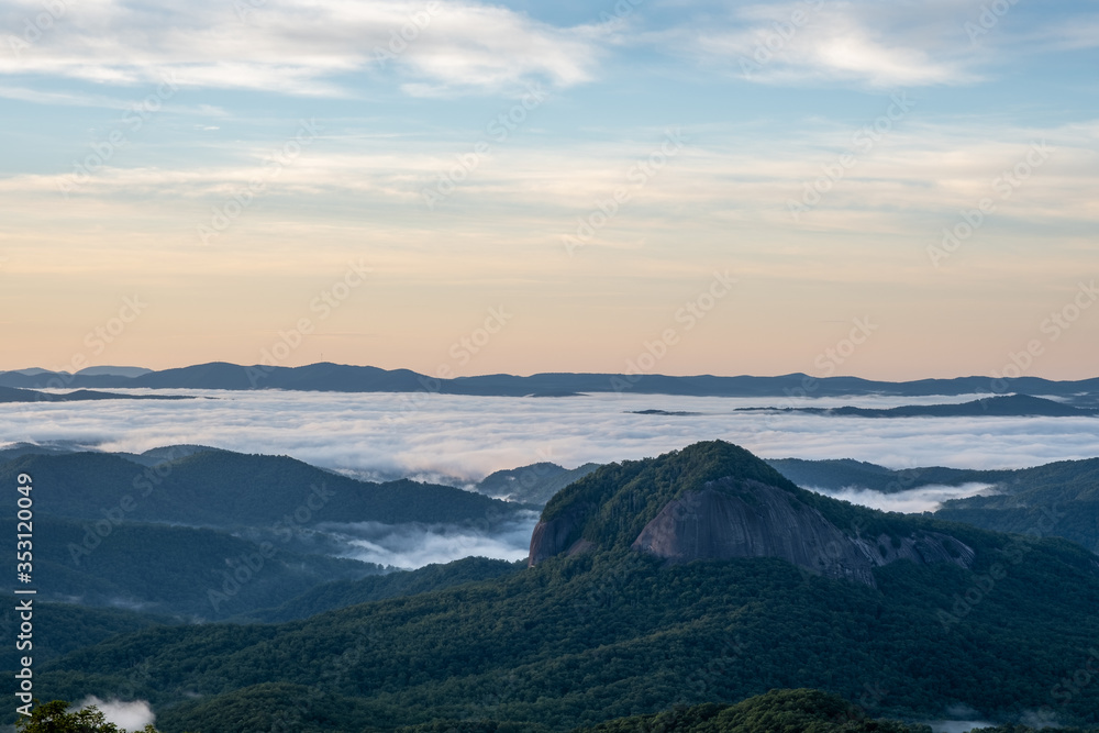 Scenic sunrise view from the Blue Ridge Parkway of Looking Glass Rock, a popular climbing and hiking destination attraction in Pisgah Forest of Brevard, near Asheville, North Carolina