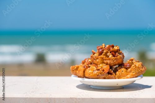 italian traditional food from Puglia region named Cartellate Pugliesi, crispy puff pastry with honey and almond