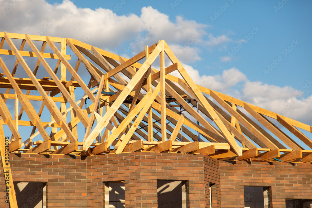 Fototapeta premium Wooden boards on the roof of the house against the sky.