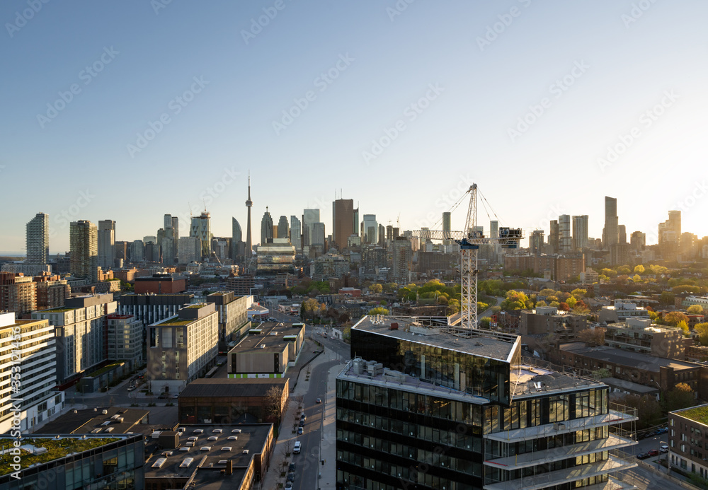 Fototapeta premium Toronto city center skyline with construction crane golden hour sunset light
