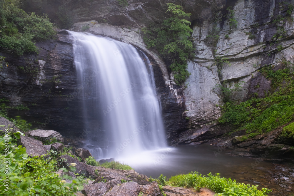 Looking Glass Falls, a large waterfall near Asheville, North Carolina in the town of Brevard in the Pisgah National Forest Looking Glass Falls, a large waterfall near Asheville, North Carolina in the town of Brevard in the Pisgah National Forest