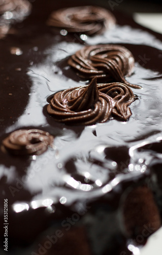 chocolate cake with chocolate syrup on white ceramic plate