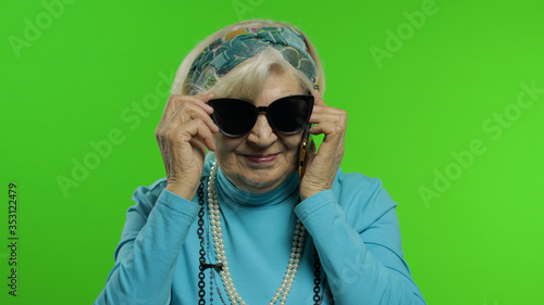 Elderly stylish caucasian grandmother woman talking on mobile phone. Chroma key