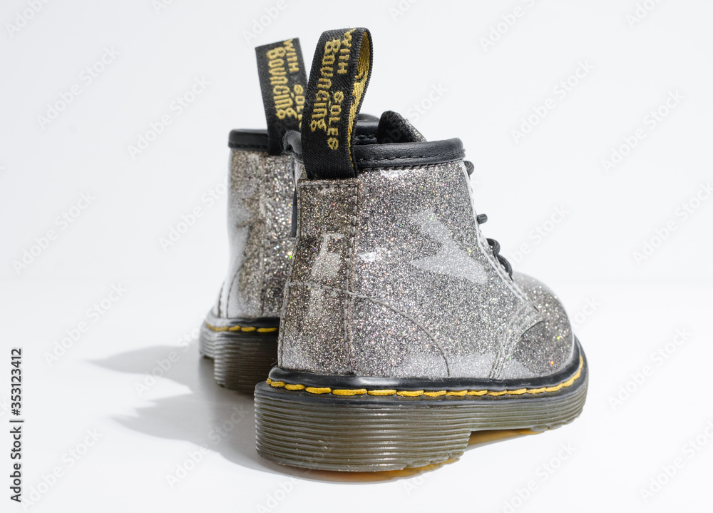 london, england, 05/05/2019 Dr Martens toddler infants silver glitter  Leather doc martens baby Boots, 4 Eye lace hole. fashionable punk historic  british made leather boots. dr martens air ware Stock Photo | Adobe Stock