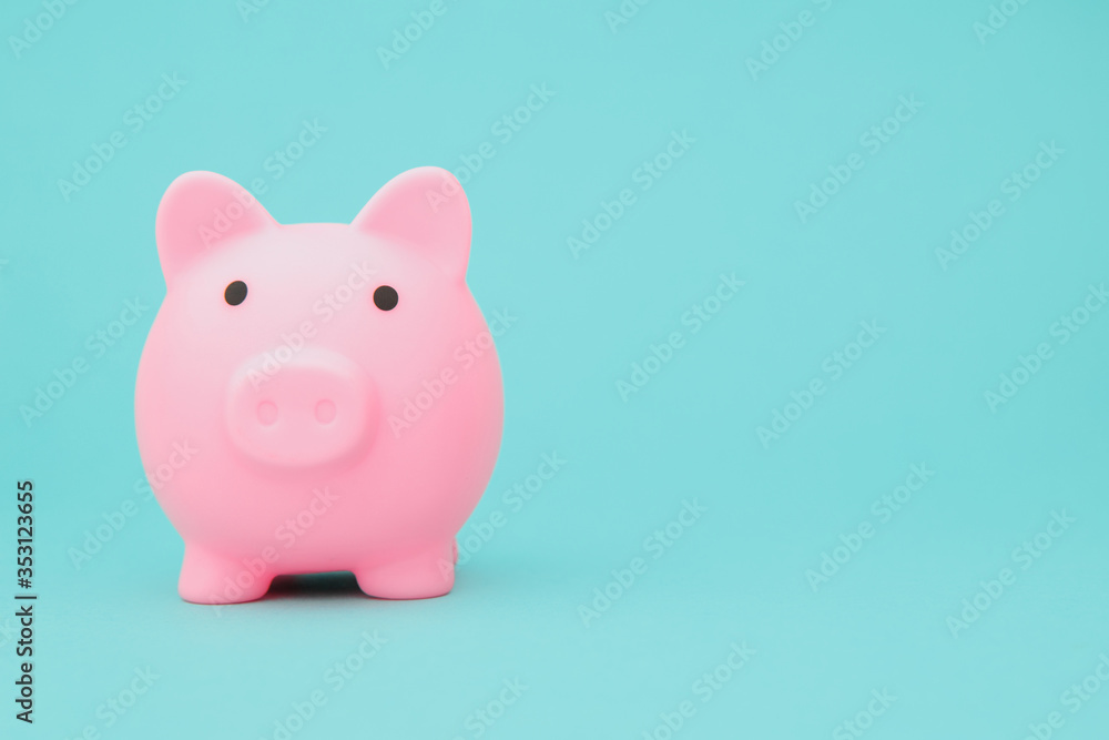 Savings concept. Moneybox in shape of pig on blue background space for text. Savings concept. Moneybox in shape of pig on blue background space for text.