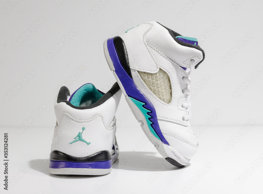 london, england, 05/05/202 White, purple and aqua, nike air baby jordan 4  model retro trainers, for kiddies and toddlers. Air jordan basketball  sneakers. Fashionable retro style street fashion. Stock Photo | Adobe Stock