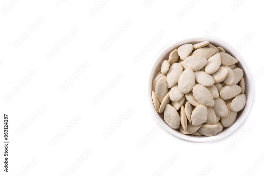 Pumpkin seeds in bowl isolated on white background. Top view. Copy space Pumpkin seeds in bowl isolated on white background. Top view. Copy space