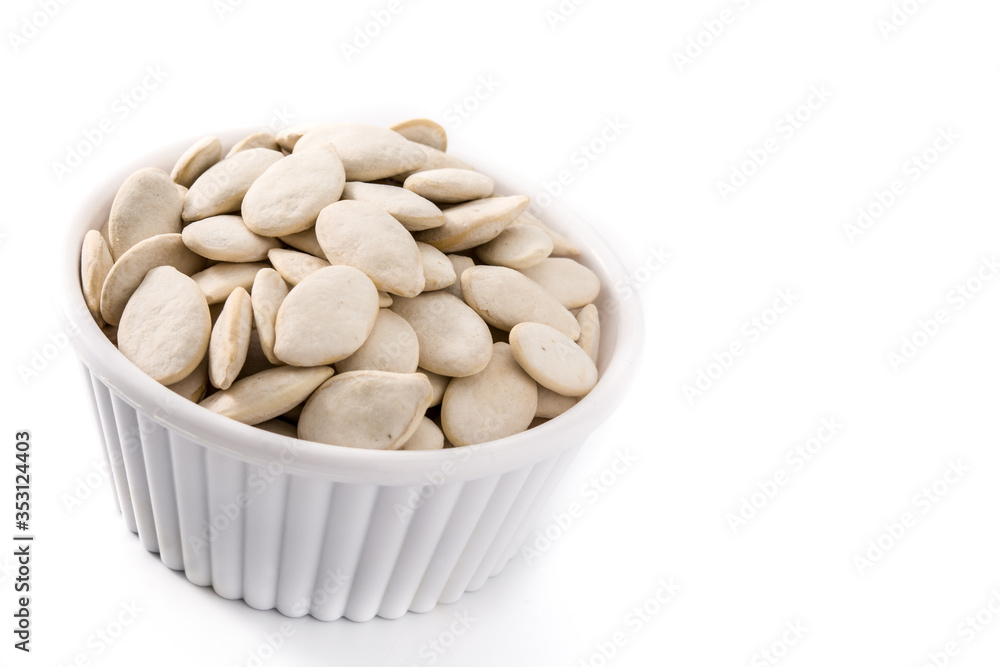 Pumpkin seeds in bowl isolated on white background. Copy space Pumpkin seeds in bowl isolated on white background. Copy space