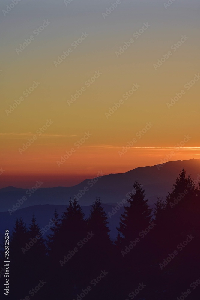 colorfully sunset over the mountains seen from high altitude